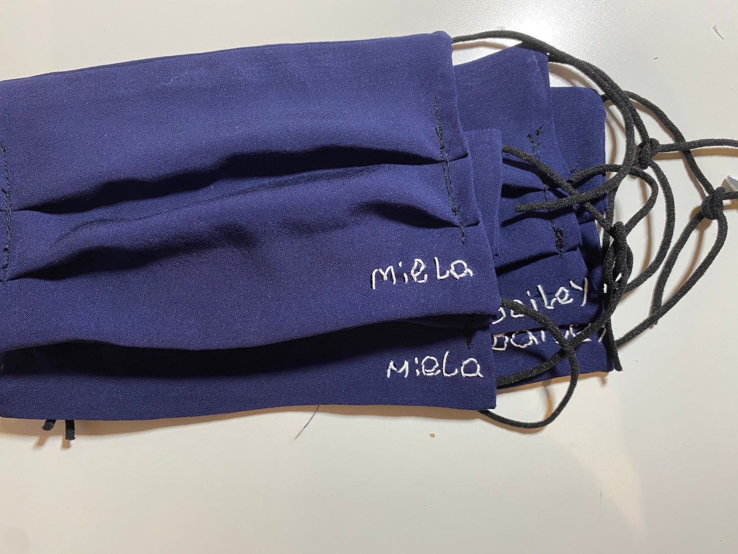 Hand stitched personalization for masks