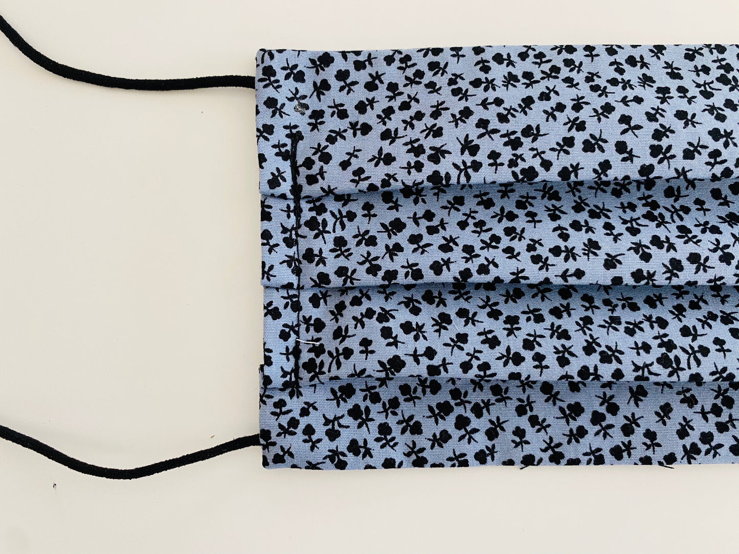 Black and blue re- usable adjustable face cover